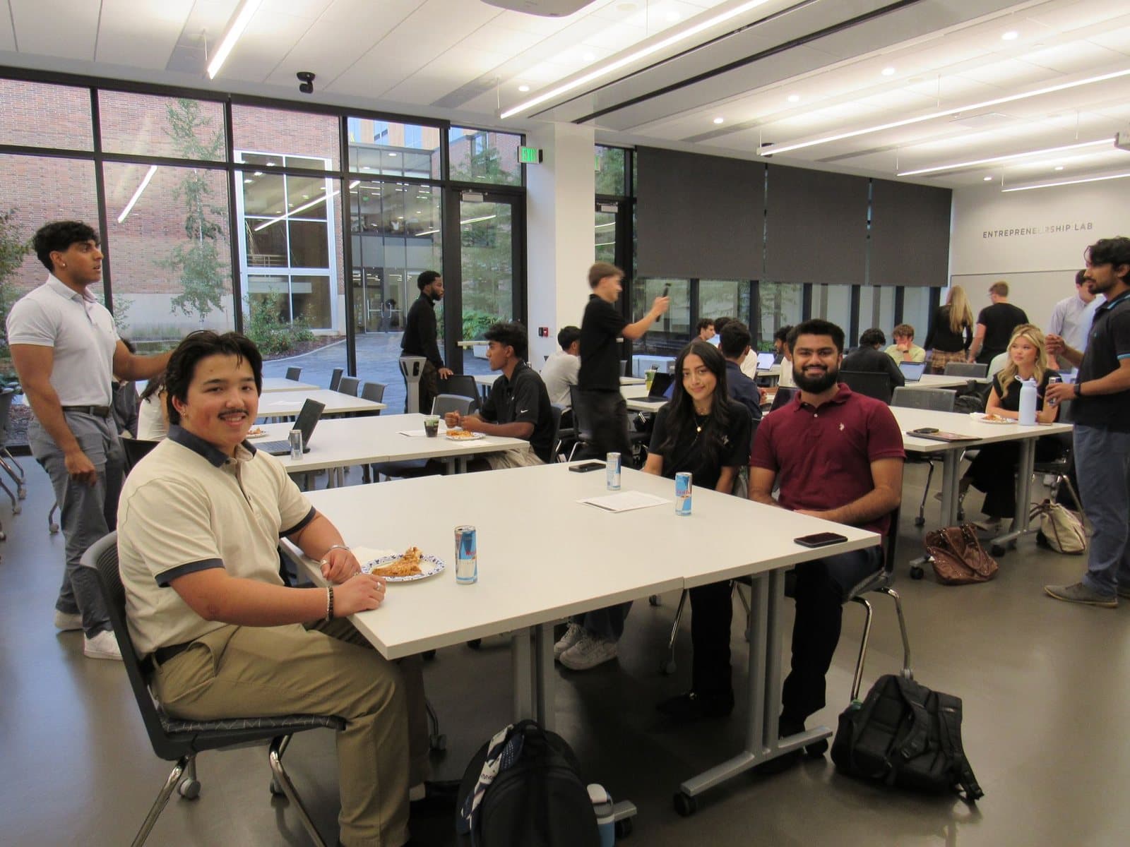 Limitless members gathered around tables during an organization event.