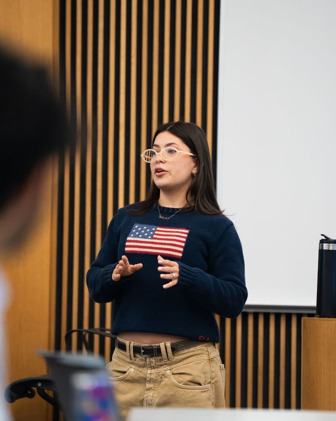 A Limitless member speaking with students during a meeting.